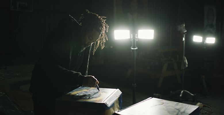 BMike in studio drawing under the lights